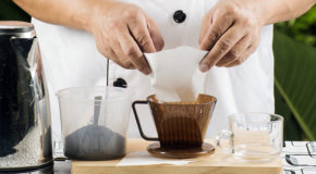 En kokk putter et filter i en filterholder for å lage traktekaffe