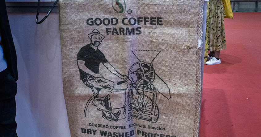 Bilde av striesekken til Good Coffee Farms, hvor Carlos Menen sitter på en sykkel