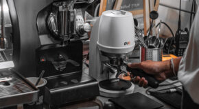 En barista bruker PUQpress mini til å tampe kaffe