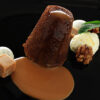 En sticky toffee pudding er pent dandert på en svart tallerken